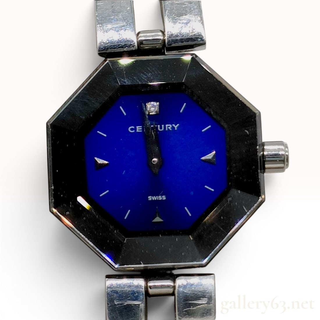 Century Time Gem Stainless Steel Ladies Wristwatch: This ladies wristwatch by Century is from the Time Gem collection. It features an octagonal stainless steel case topped with a signature faceted black sapphire bezel. The blue dial is accented with a 