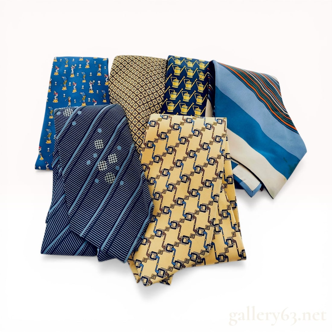 A Collection of Six Designer Silk Neckties Including Salvatore Ferragamo, Fendi, and Yves Saint: Lot of six men's designer silk neckties featuring examples from Salvatore Ferragamo, Fendi, and Yves Saint Laurent. Patterns include a blue Ferragamo sport novelty print with athletes on pedestals, a 