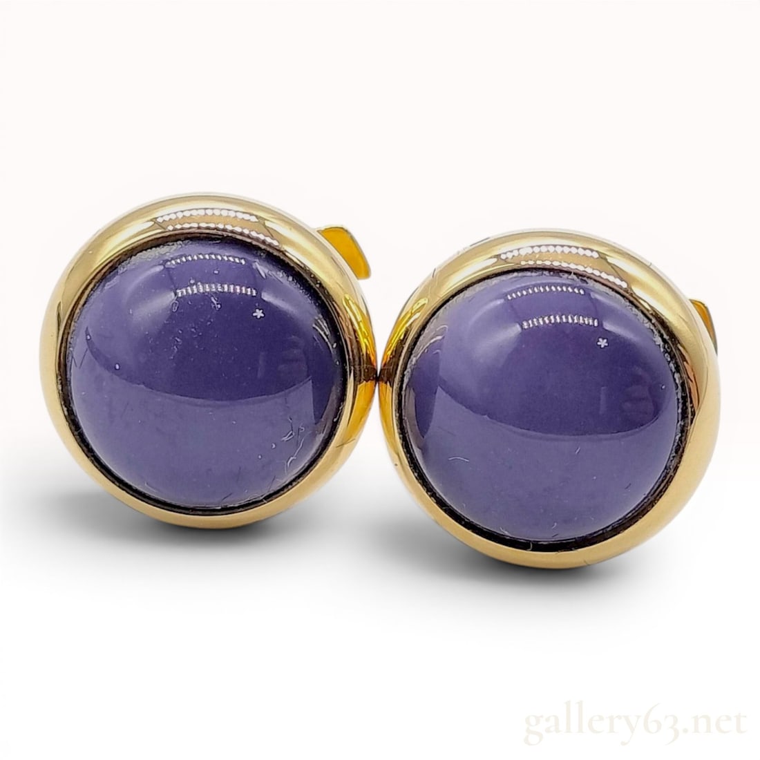 A Pair of Hermes Gold-Toned and Purple Cabochon Stud Earrings with Box: A matched pair of Hermes stud earrings in gold-toned metal. Each earring features a circular bezel-set, domed purple cabochon. The reverse of each earring is stamped HERMES followed by a small square 