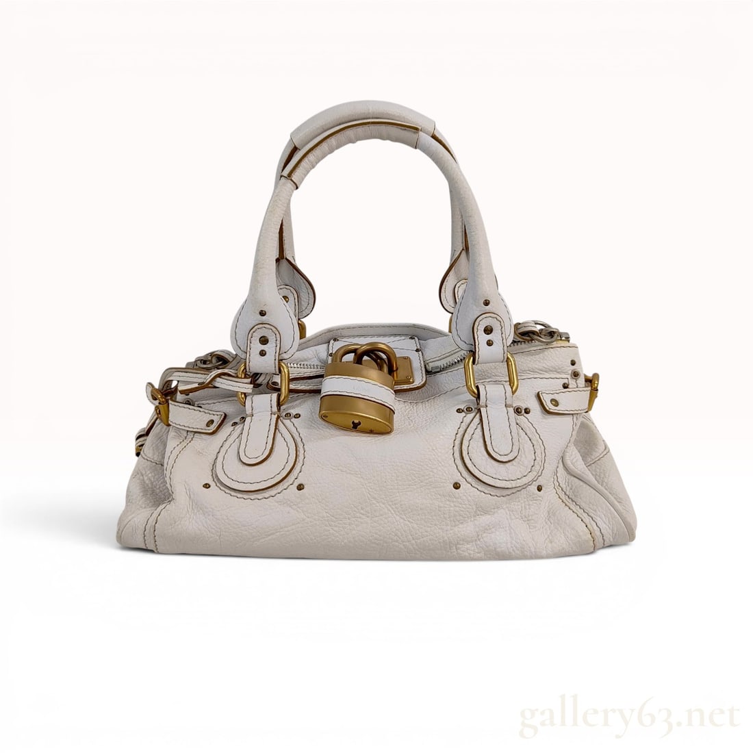 Chloe Paddington Satchel in Cream Pebbled Leather: A Chloe Paddington satchel crafted from cream-colored pebbled leather. This iconic design features dual rolled leather top handles with signature C-shaped leather overlays at the handle bases. The bag