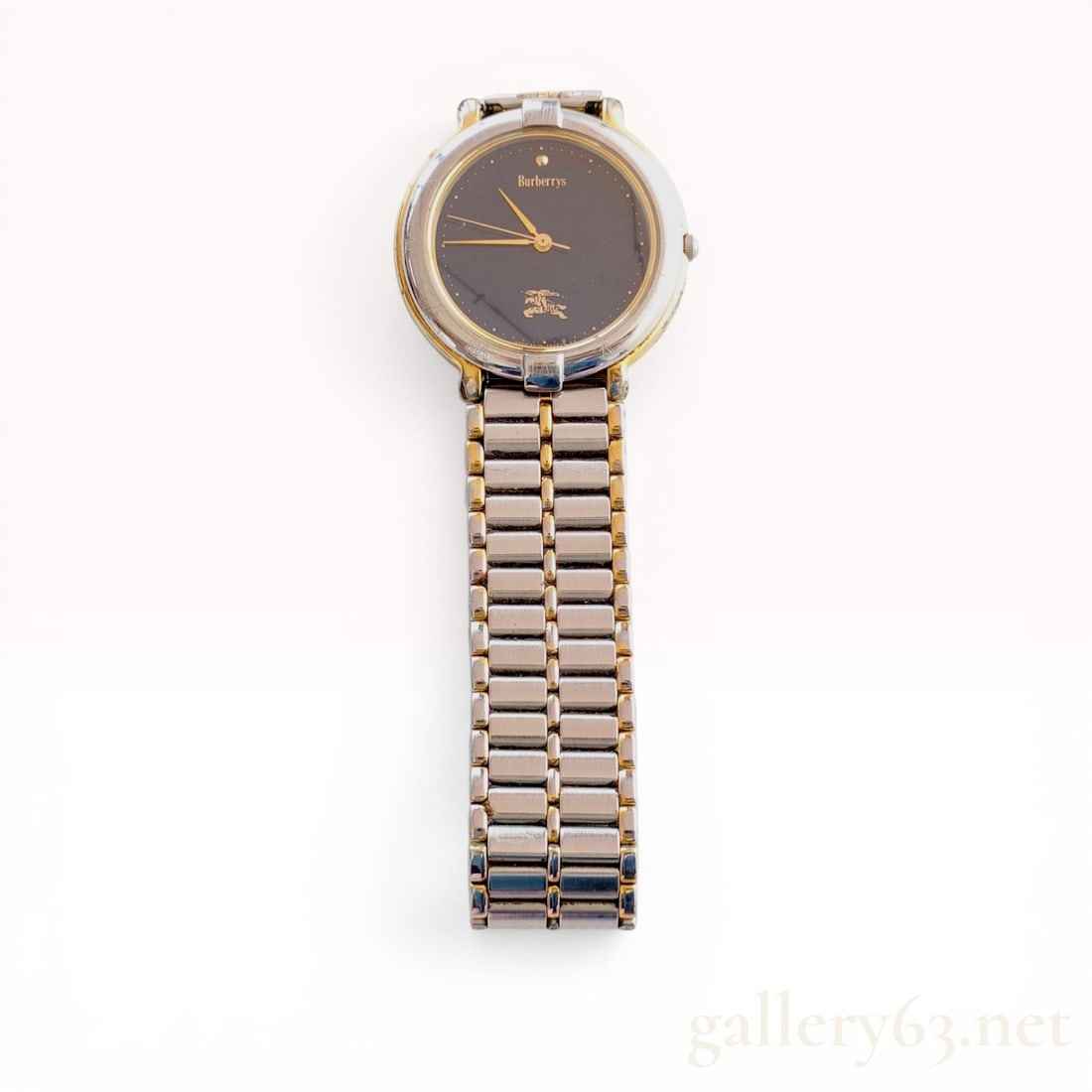 Burberrys Two-Tone Quartz Wristwatch Reference 4630-E61343 KA: Burberrys vintage quartz wristwatch manufactured by Citizen, late 20th century. The timepiece features a two-tone base metal and stainless steel case housing a black dial with gold-tone hands and the 