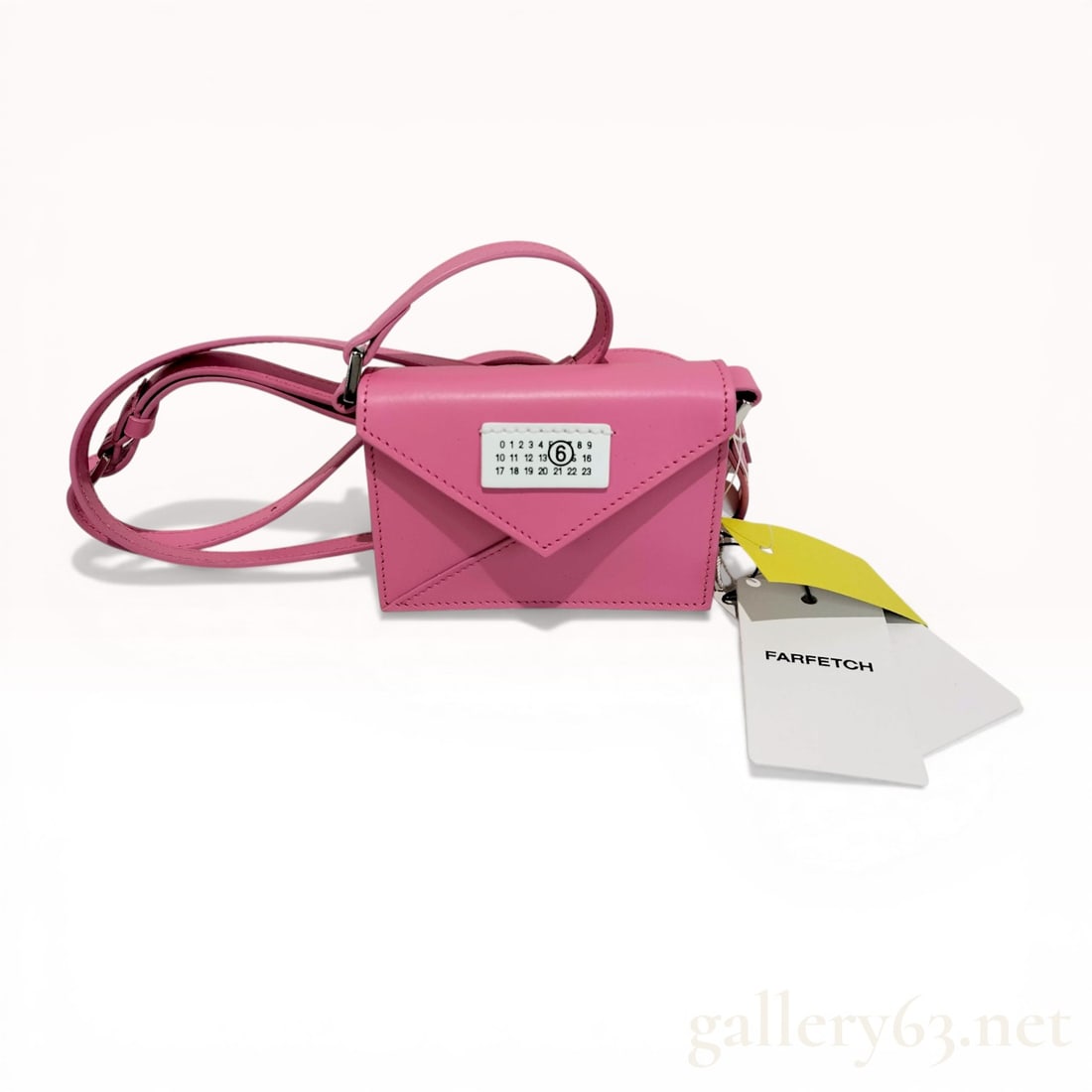 MM6 Maison Margiela Micro Japanese Crossbody Bag in Pink Leather: MM6 Maison Margiela Micro Japanese crossbody bag, contemporary. Crafted from bright pink smooth calf leather, the bag features an origami-inspired folded construction and polished silver-tone hardware