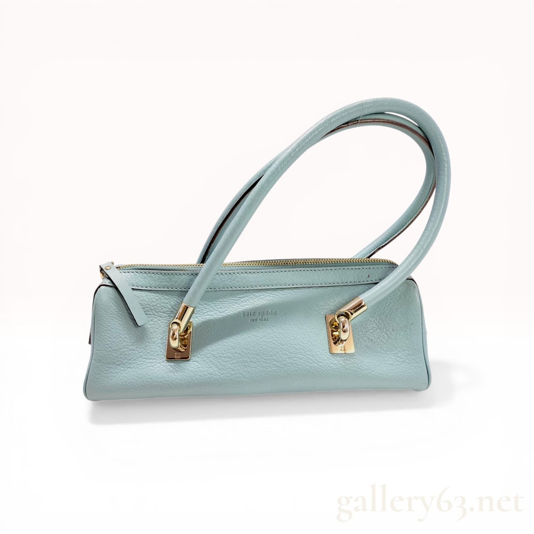 Kate Spade New York Light Blue Pebbled Leather Baguette Shoulder Bag: Kate Spade New York baguette-style shoulder bag in light blue pebbled leather. This item features gold-tone hardware, rolled leather shoulder straps, and a top zipper closure. The interior is finished