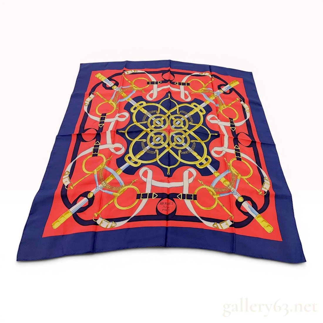 Hermes Eperon dOr Silk 90cm Square Scarf: A Hermes 100 percent silk carre scarf featuring the Eperon dOr equestrian pattern. The design consists of an intricate arrangement of bridles, straps, bits, and buckles in gold, white, and light blue 