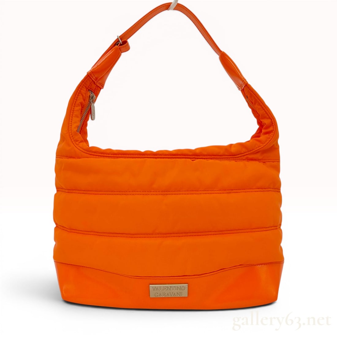 Valentino Garavani Sport Orange Quilted Nylon Hobo Bag: This is a bright orange quilted puffer-style shoulder bag from the Valentino Garavani Sport line. The bag features a padded nylon body with tonal high-shine trim along the base and shoulder strap. It 