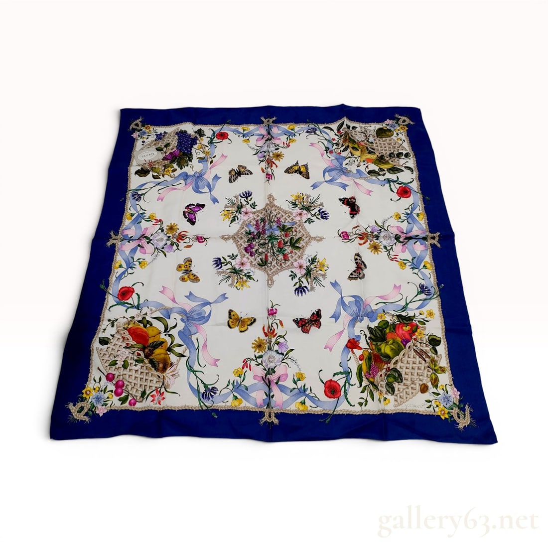 Gucci Vittorio Accornero Flora Silk Scarf: A vintage silk scarf by Gucci featuring the Flora pattern designed by artist Vittorio Accornero. The central ivory field is decorated with a variety of colorful flowers, four overflowing baskets at th
