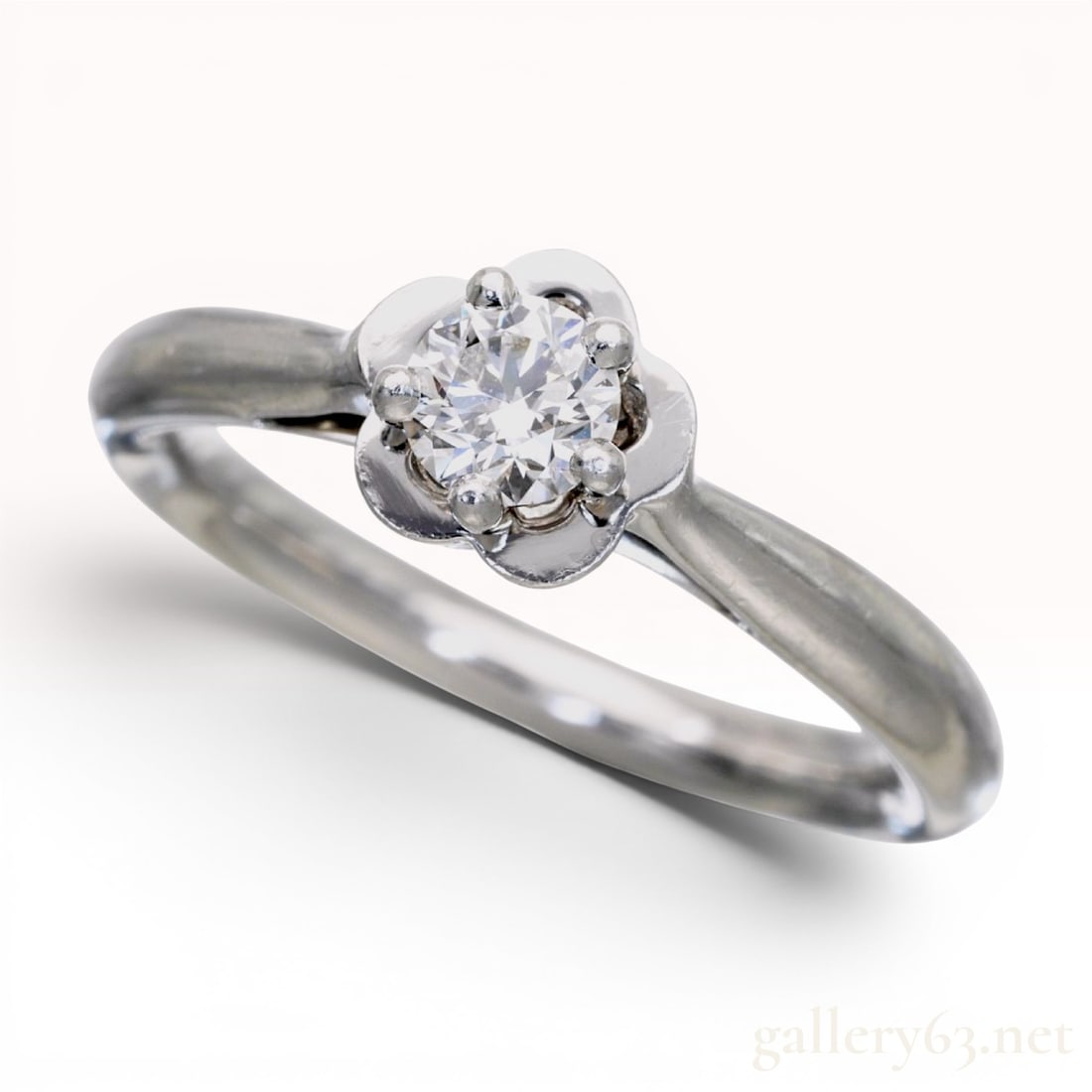 Chanel Camelia Platinum and D-VVS1-EX Diamond Solitaire Ring W/GIA Report: A Chanel Camelia collection diamond solitaire ring crafted in 950 platinum. The design features a central round brilliant-cut diamond secured in a four-prong mounting stylized as a camellia flower. As
