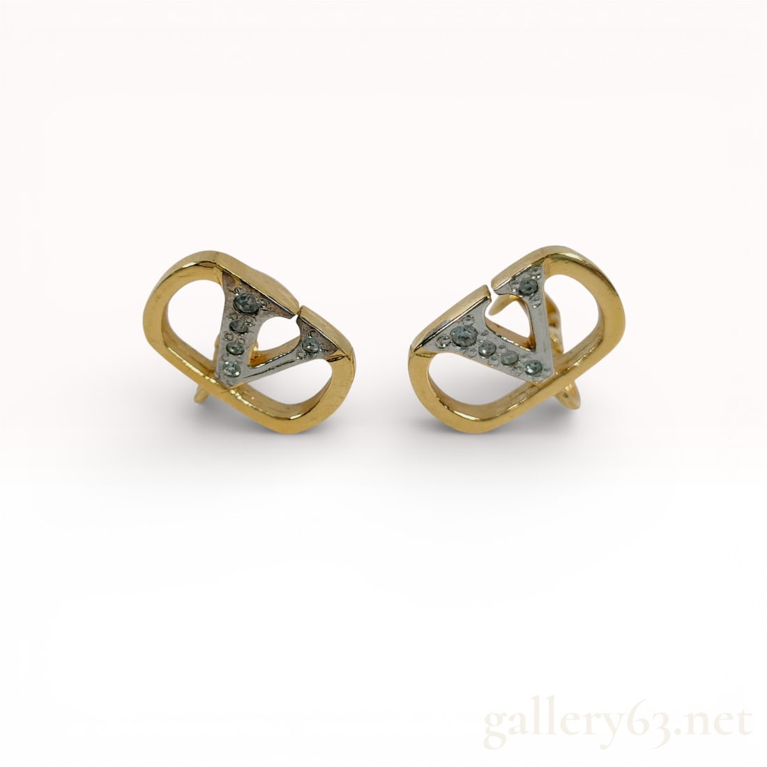 A Pair of Valentino Garavani VLogo Signature Clip-On Earrings: Valentino Garavani VLogo Signature clip-on earrings. The two-tone design features a silver-tone VLogo pave-set with round clear crystals within a yellow gold-tone oval frame. Each earring is stamped V
