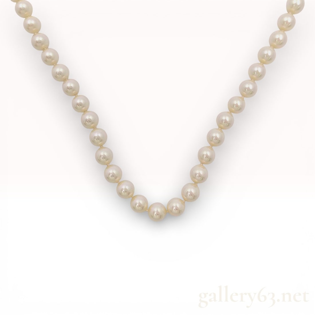 Christian Dior Vintage Simulated Pearl Single Strand Necklace: Christian Dior vintage single-strand simulated pearl necklace. The strand features uniform cream-white faux pearls hand-knotted on coordinating thread and finished with a silver-tone base metal fold-o