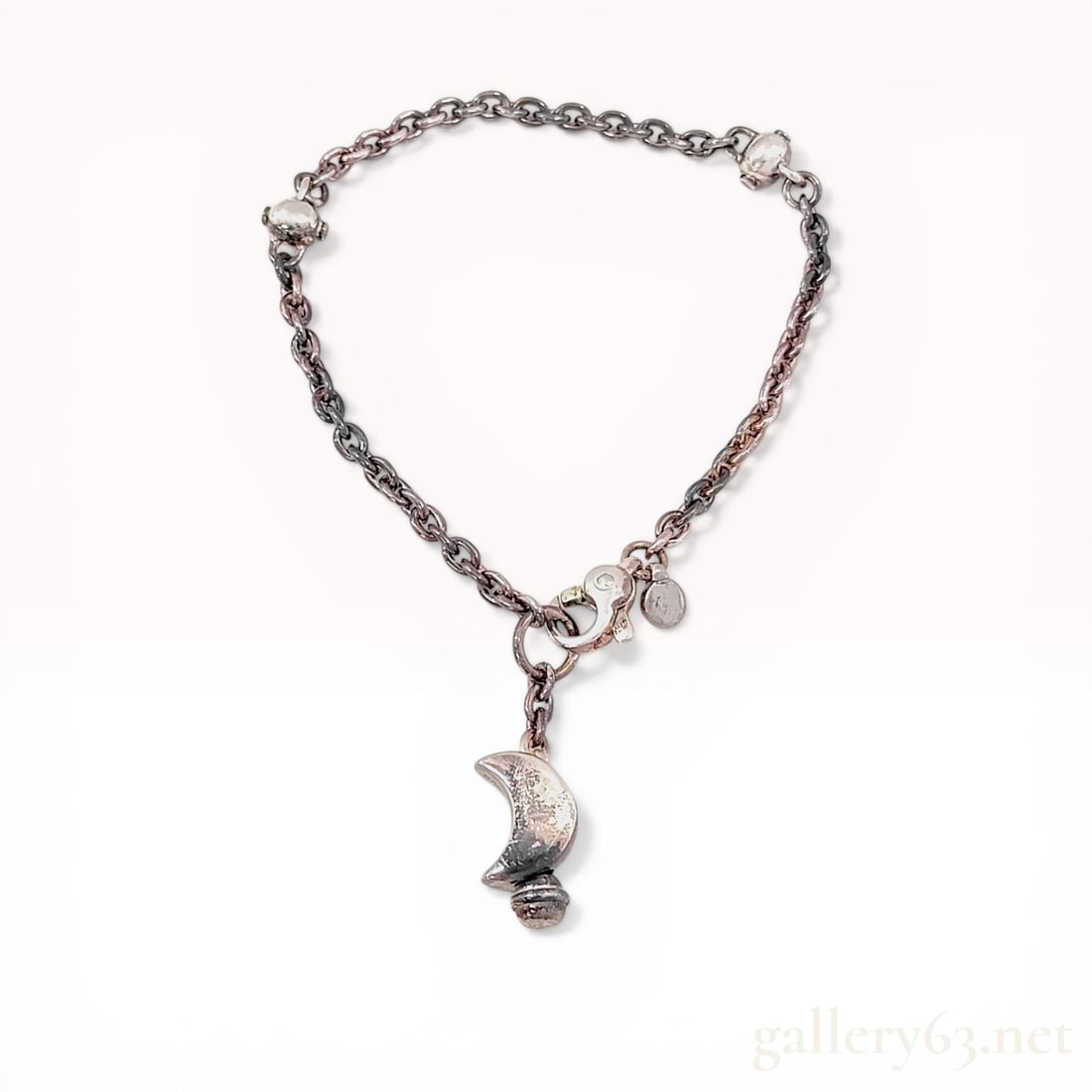 MECCA Italy Sterling Silver Moon Charm Bracelet: Sterling silver link chain charm bracelet by MECCA, Italy. The piece features an oval link chain accented with two integrated spherical beads and a central crescent moon-shaped drop charm with a decor