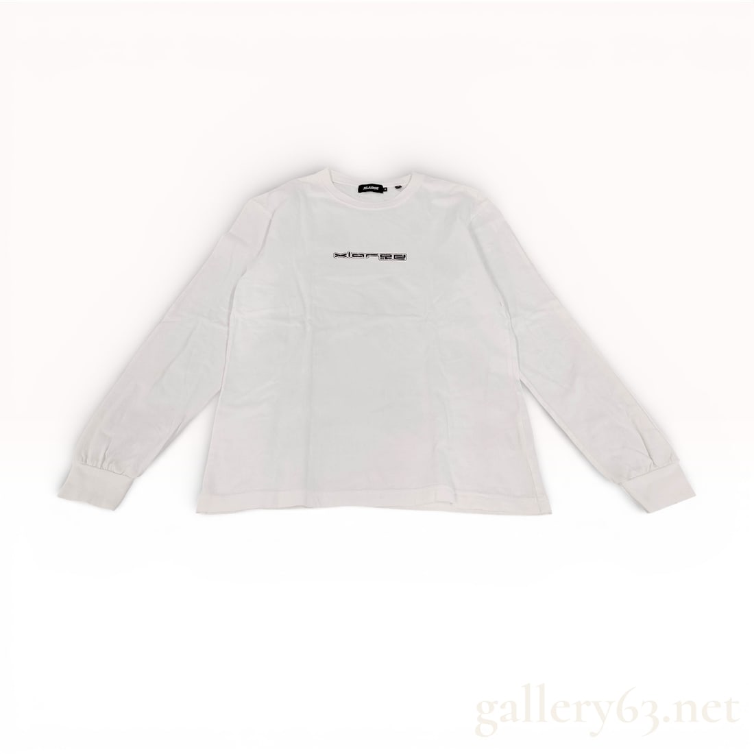 XLARGE White Cotton Long Sleeve Graphic Tee size M: XLARGE long sleeve trainer top featuring white cotton construction. Crew neckline having ribbed trim with straight hem and cuffed sleeves. Front chest featuring a small black XLARGE logo text print. B