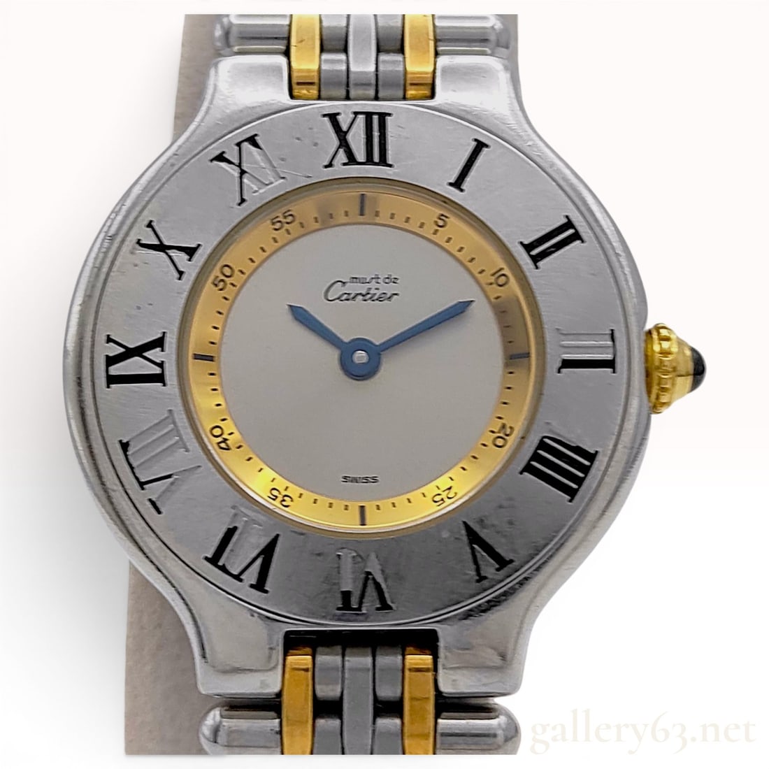 Must de Cartier 21 Reference 1340 Two Tone Stainless Steel Quartz Wristwatch: A Must de Cartier 21 reference 1340 quartz wristwatch. The timepiece features a stainless steel case with a fixed bezel engraved with black Roman numerals I through XII. The dial is composed of a silv