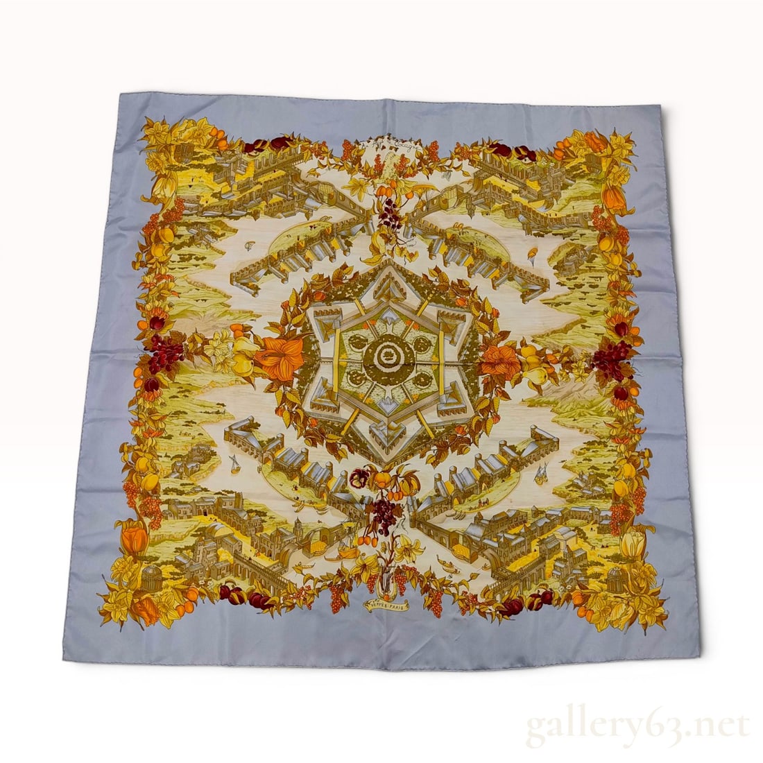 Hermes Carre 90 Silk Scarf Au Pays de Cocagne: This authentic Hermes silk twill scarf features the Au Pays de Cocagne (The Land of Plenty) pattern, designed by artist Zoe Pauwels. The intricate illustrative composition depicts an idealized landsca