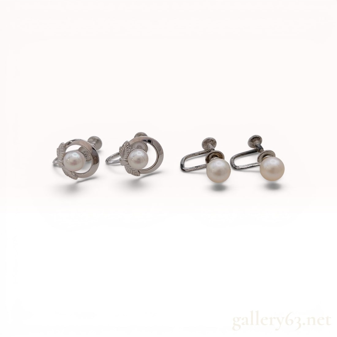 A Group of Vintage Mikimoto and Silver Cultured Pearl Screw-Back Earrings w/Box: Mikimoto and silver cultured pearl screw-back earrings, mid-20th century. Collection includes one pair featuring pearls within foliate-motif circular frames and one pair of solitaire pearl studs on wh