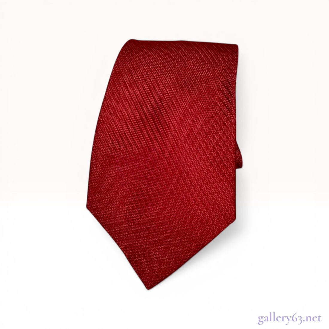 Celine Crimson Red Textured Silk Necktie: Celine men's necktie, contemporary. Crimson red 100% silk featuring a prominent diagonal repp-weave texture and a tonal jacquard-woven interlocking C logo lining at the tip. The reverse includes a bra