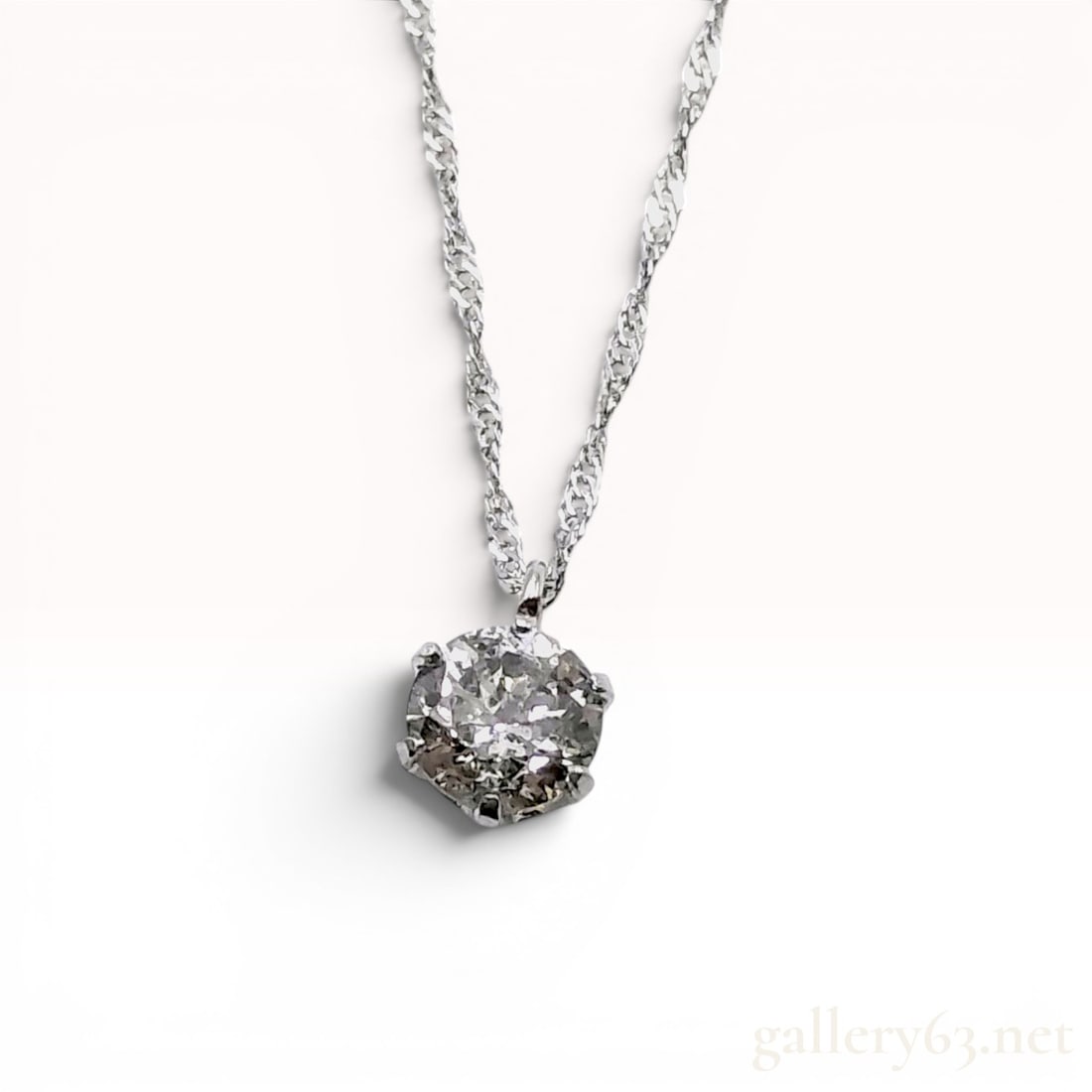 Platinum and 0.40 Carat Diamond Solitaire Pendant Necklace: A platinum and diamond solitaire pendant necklace featuring a single round brilliant cut diamond. The diamond is secured in a six-prong basket-style setting suspended from a fine twisted Singapore lin
