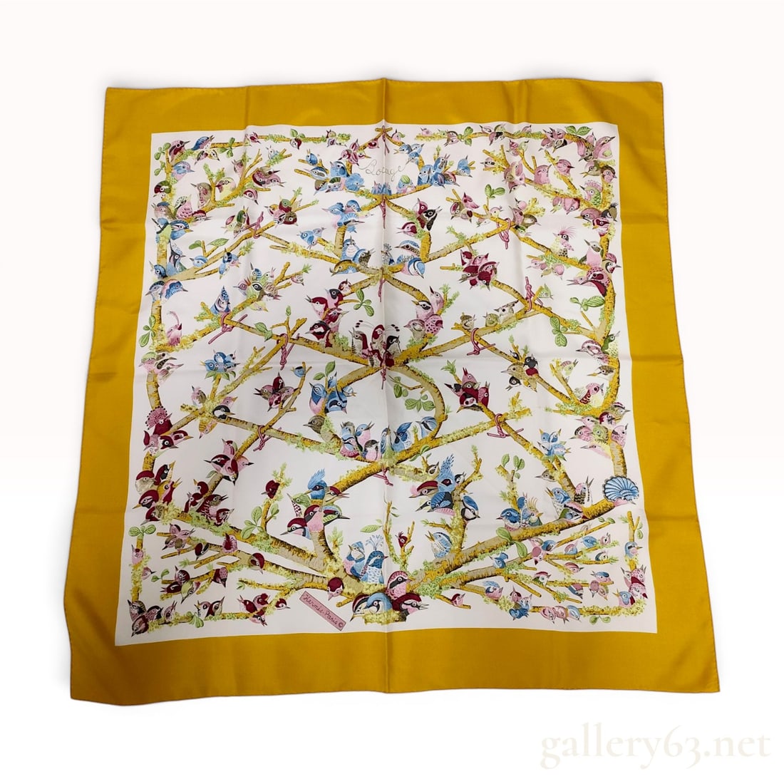 Hermes Bocage Silk Carre 90 Scarf by Loic Dubigeon: This square silk twill scarf, titled Bocage, was designed by artist Loic Dubigeon for the French luxury brand Hermes. The pattern features a dense arrangement of colorful songbirds perched on lichen-c