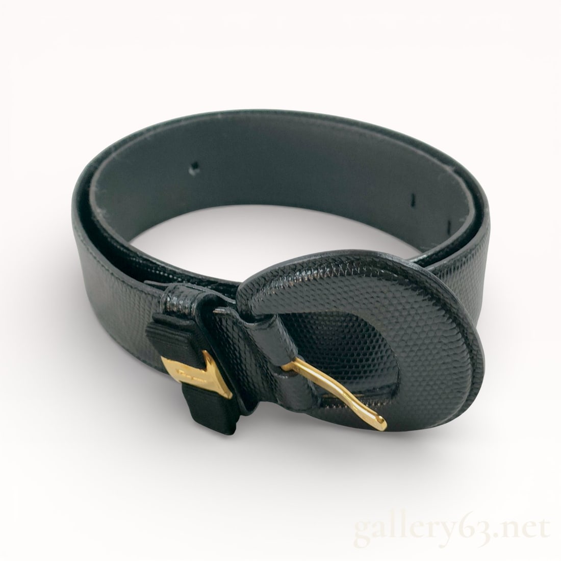Salvatore Ferragamo Vara Ribbon Lizard Belt: Authentic Ferragamo belt made with a black textured leather strap, having a rounded tip and evenly spaced adjustment holes. Design featuring an oval buckle covered in matching textured leather, fitted