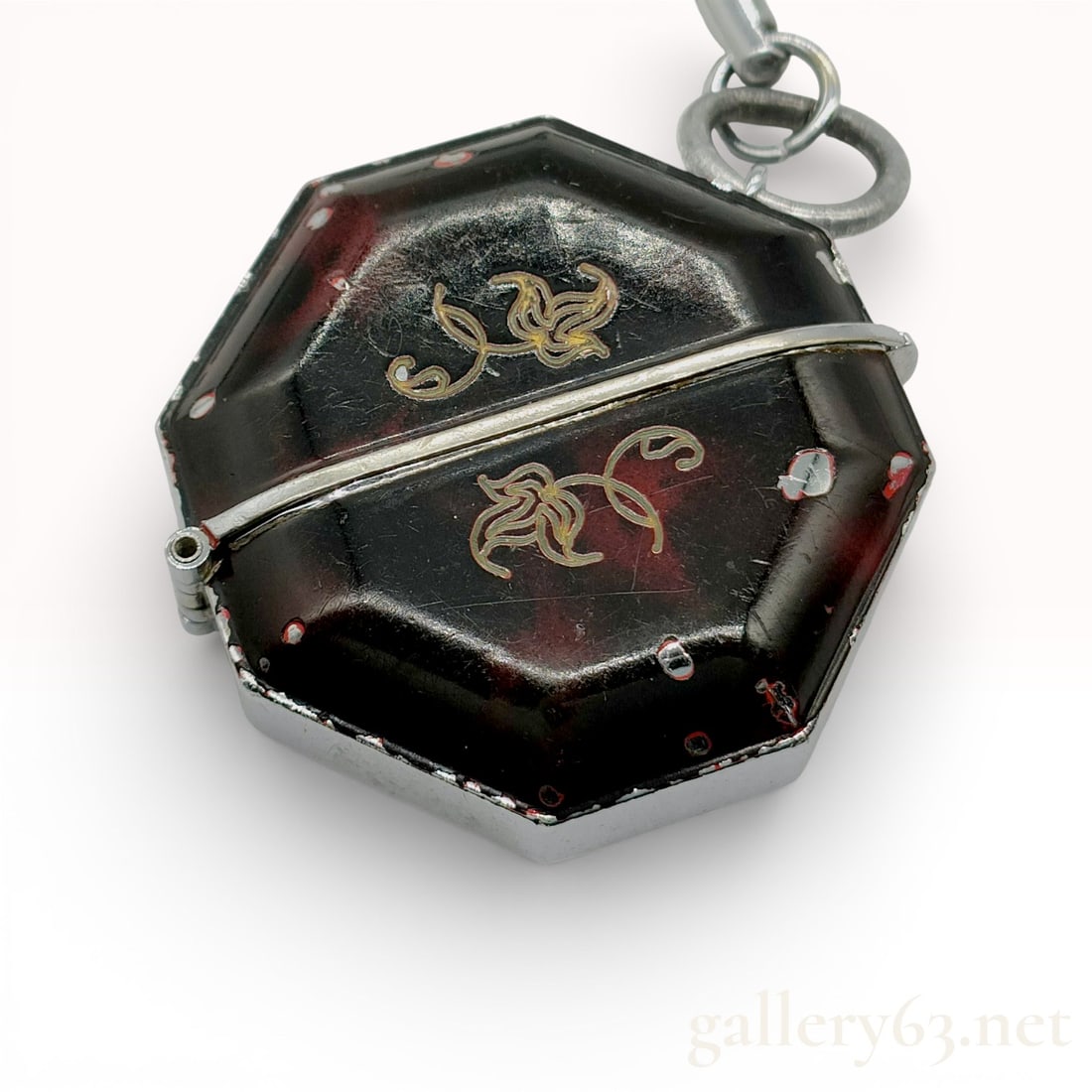Seiko Momotaro 21-7510 Octagonal Manual Wind Keychain Watch: Seiko Momotaro manual-wind keychain watch, model 21-7510, mid-20th century. The octagonal folding clamshell case features a dark reddish-brown marbled exterior with gold-tone floral scrollwork and a s