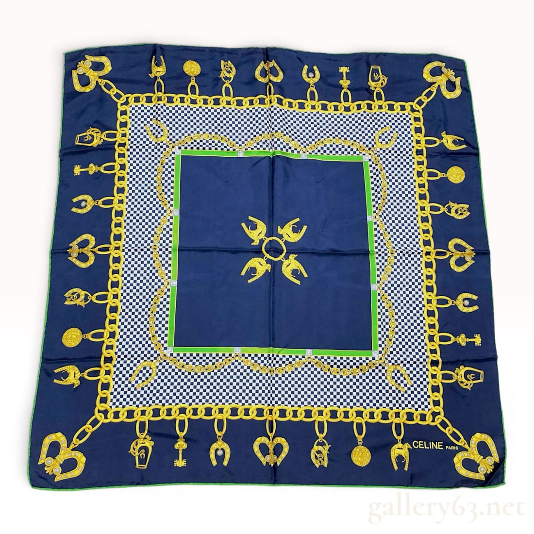 Celine Paris Equestrian Motif Silk Scarf: A vintage square silk scarf by Celine Paris featuring an equestrian-themed design. The center is a solid navy blue square with a central motif of four horses integrated into horseshoes joined by a gol