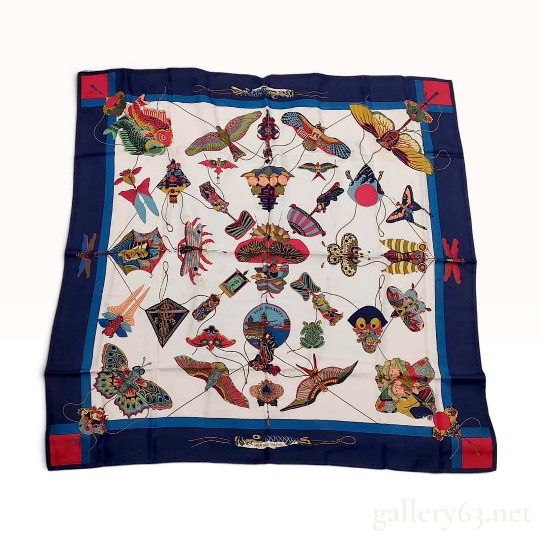 Hermes Soies Volantes Silk Scarf by Loic Dubigeon: This Hermes silk carre features the Soies Volantes (Flying Silks) pattern designed by Loic Dubigeon, originally introduced in 1992. The design displays an intricate variety of traditional decorative k