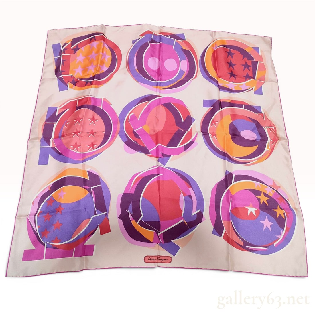 Salvatore Ferragamo Gancini Motif Silk Scarf: Salvatore Ferragamo square silk scarf featuring a graphic abstract design of a 3x3 grid of the Gancini logo. Each circular emblem contains geometric patterns, stars, and dots in a palette of magenta, 