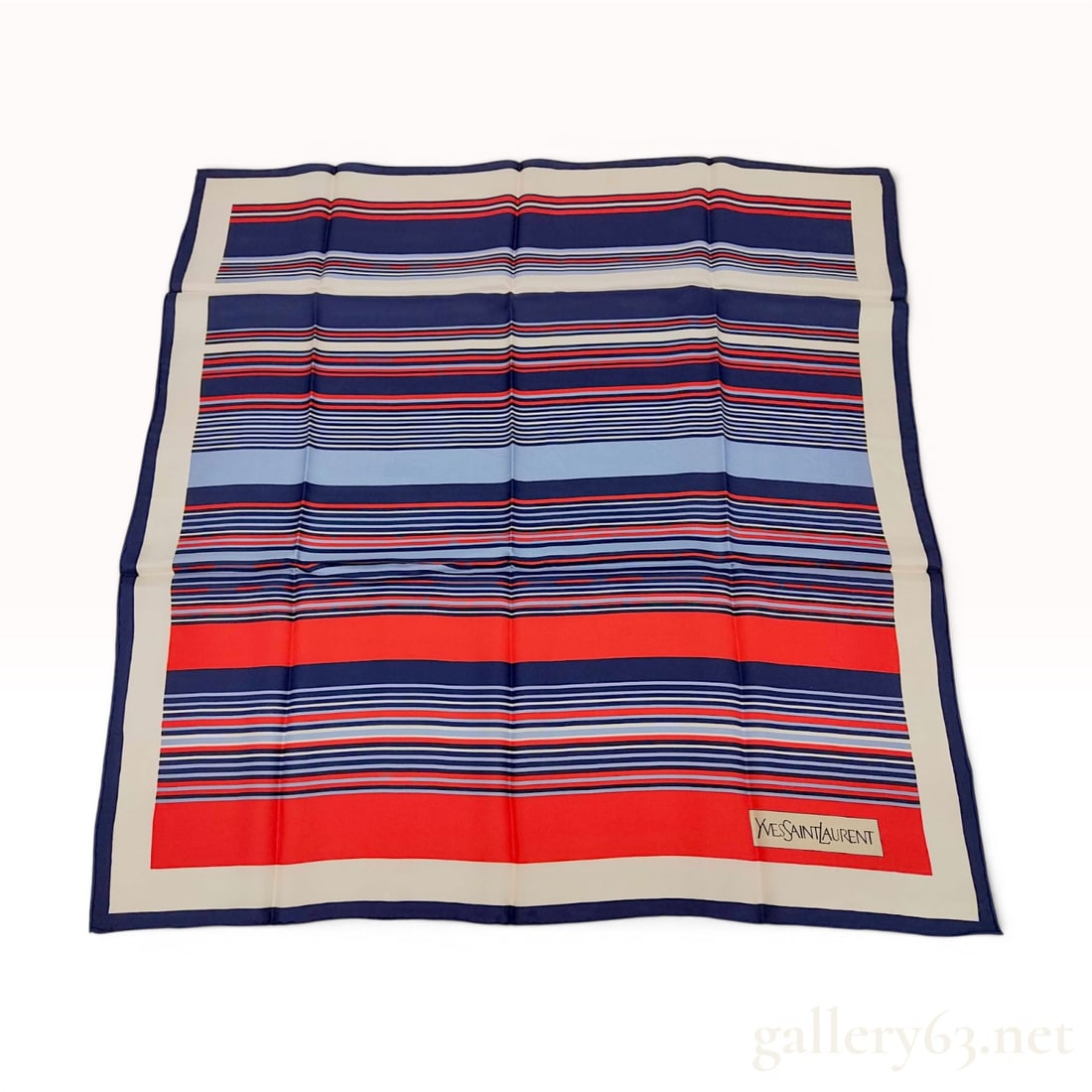 Yves Saint Laurent Striped Silk Scarf: An Yves Saint Laurent silk scarf featuring a pattern of multi-width horizontal stripes in navy blue, vibrant red, light blue, and white. The striped field is framed by a wide off-white border with a n