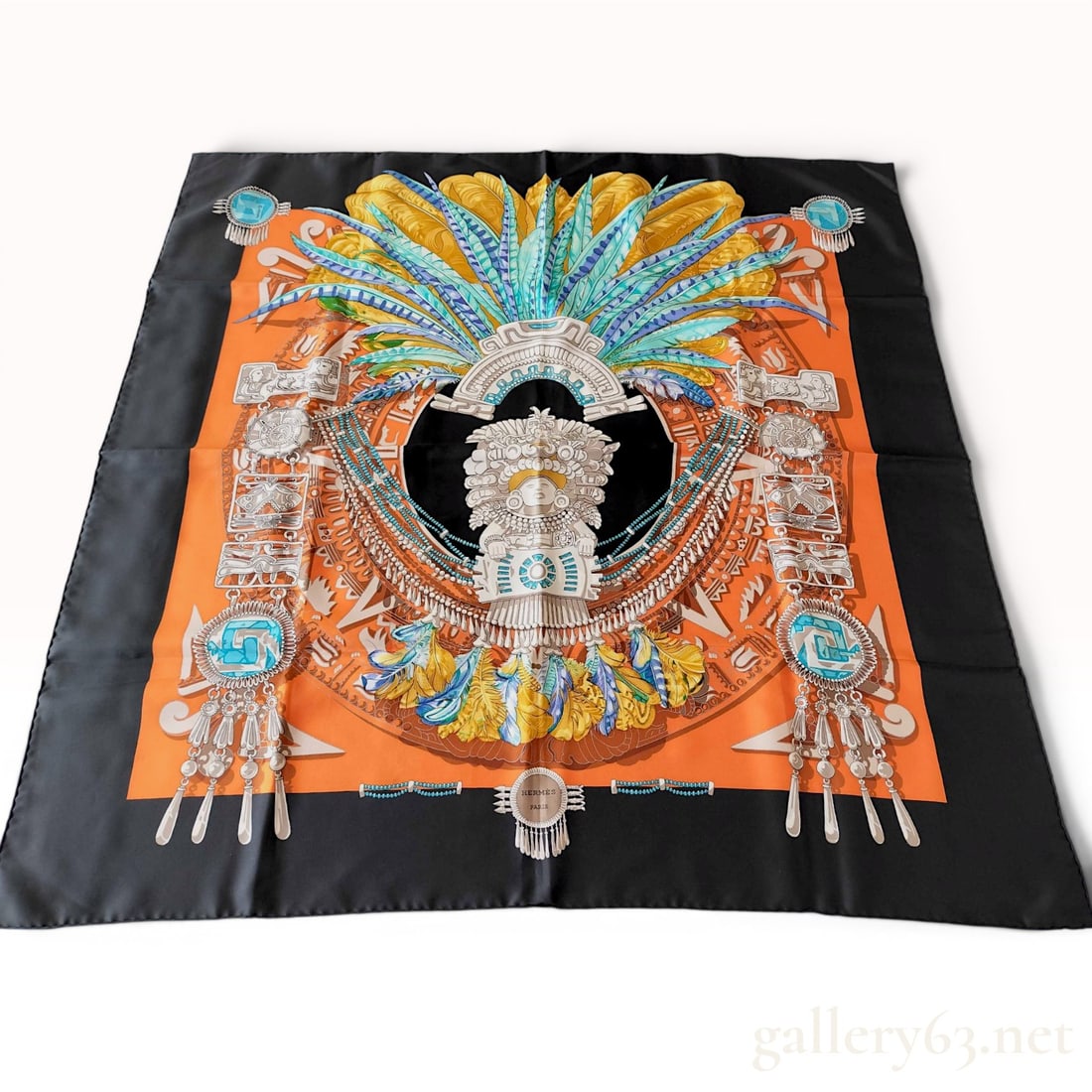 Hermes Mexique Silk Scarf: Hermes silk twill scarf featuring the Mexique pattern designed by Caty Latham. The central motif displays an Aztec or Mayan stone deity surrounded by intricate circular patterns, elaborate feathered h