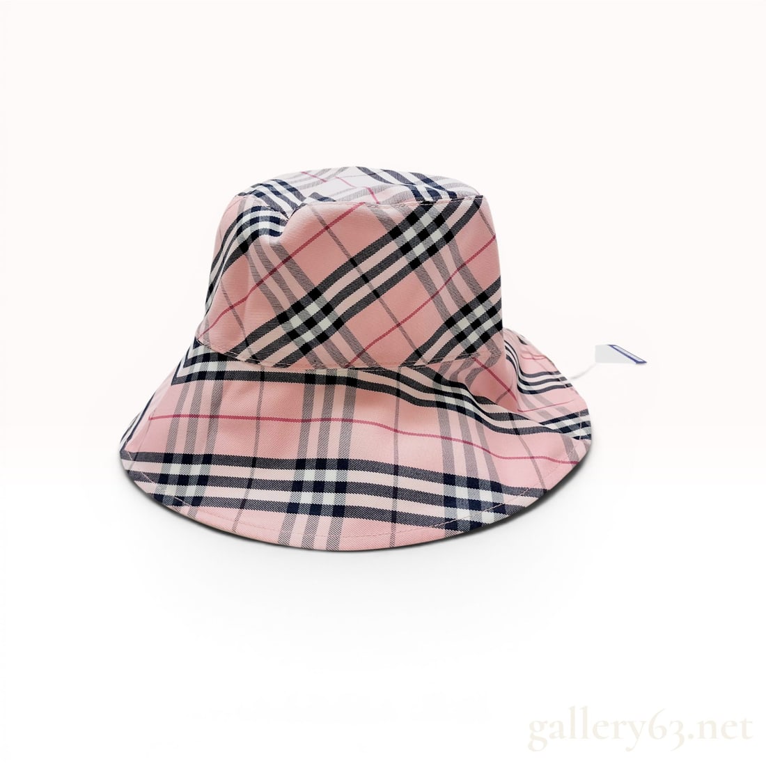 Burberry Blue Label Reversible Cotton-Blend Check Bucket Hat: Burberry London Blue Label reversible bucket hat, manufactured in Japan by Sanyo Shokai. One side features a pink signature check pattern in a cotton and polyester blend, while the reverse is solid be