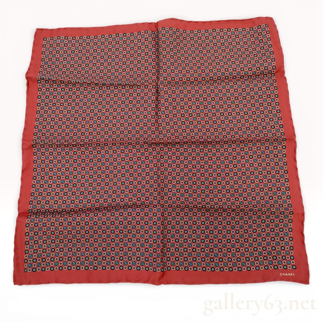 Chanel Silk Twill Pocket Square with Geometric CC Logo Pattern: Chanel silk twill pocket square, late 20th to early 21st century. Repeating geometric pattern of concentric circles and rounded squares in red, white, and blue on a coral ground with integrated interl