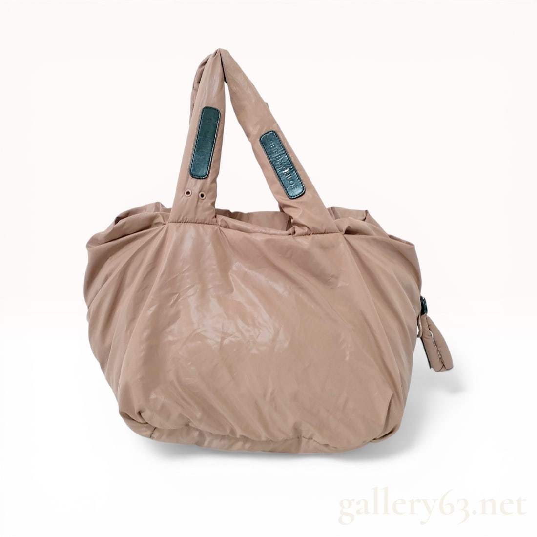See by Chloe Joy Rider Padded Nylon Tote: See by Chloe Joy Rider padded tote bag in a dusty rose technical fabric. The design features a puffy silhouette with dual top handles accented by black leather patches and an oversized tonal resin zip