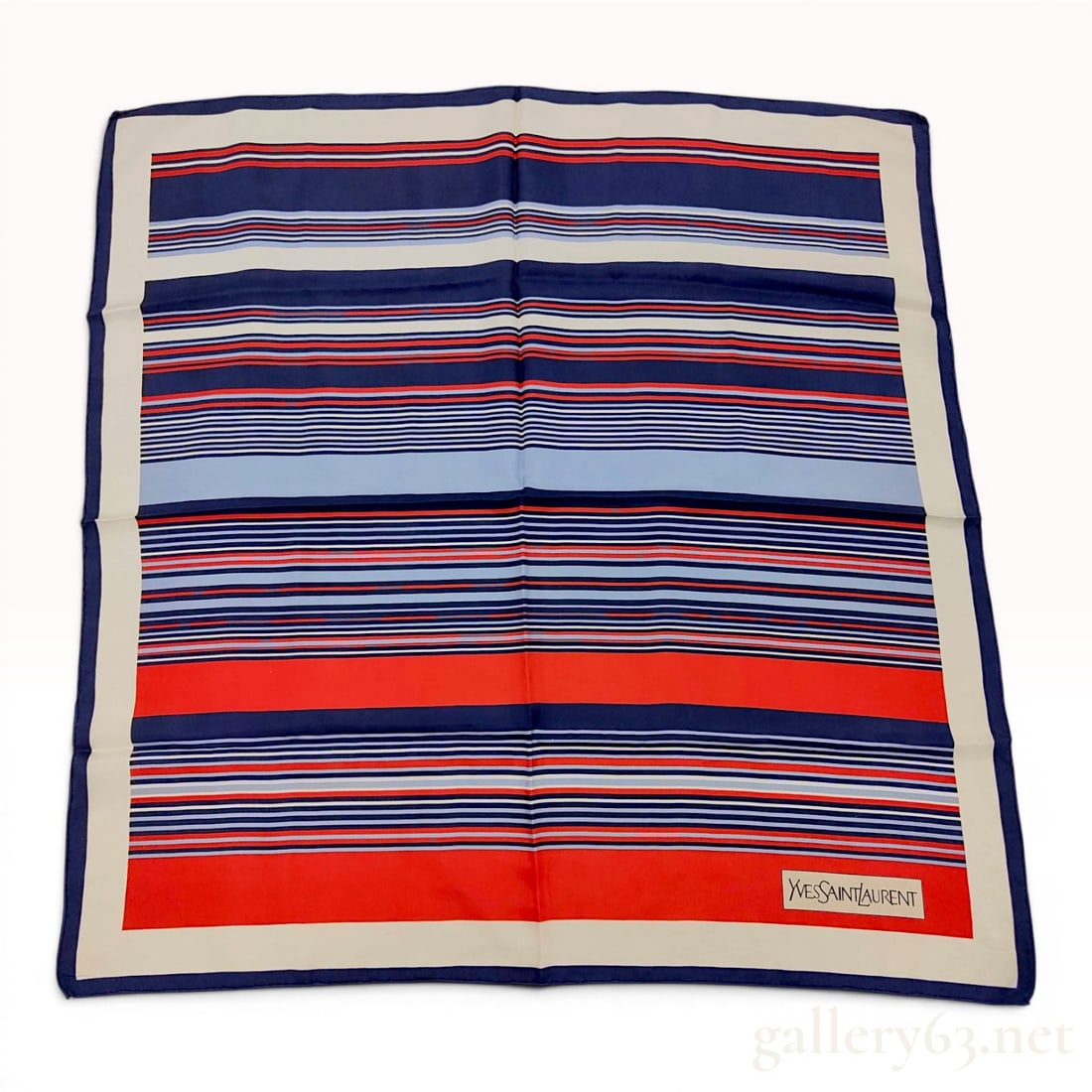 Yves Saint Laurent Vintage Striped Silk Scarf: This square scarf is constructed from silk twill and features a horizontal striped pattern in navy blue, red, light blue, and cream. It is finished with a navy blue border and hand-rolled edges. A pri