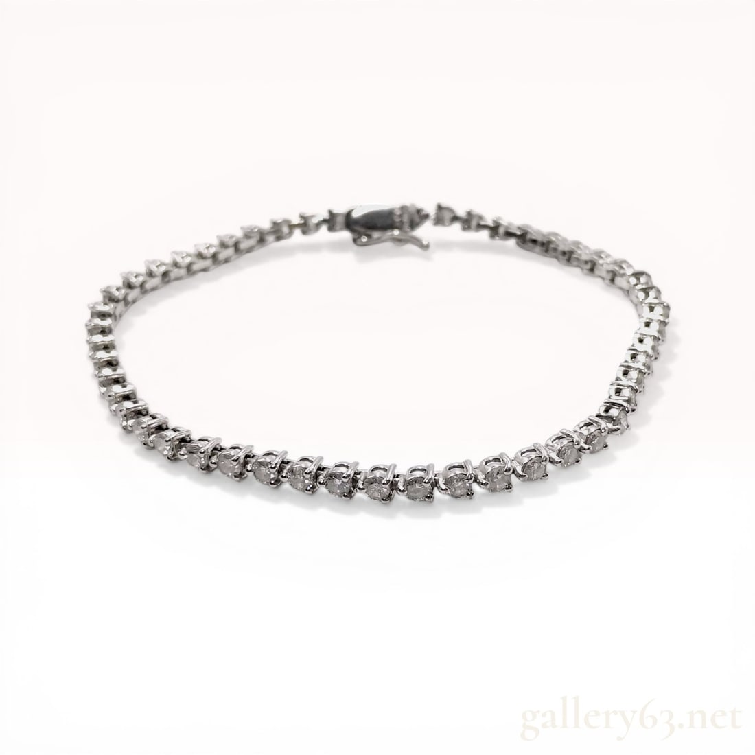 Platinum and 3.00ctw Natural Diamond Tennis Bracelet: Excellent condition. Platinum tennis bracelet featuring a continuous row of over 50 round brilliant cut diamonds, each individually set in four-prong box links. The piece is secured by an integrated b