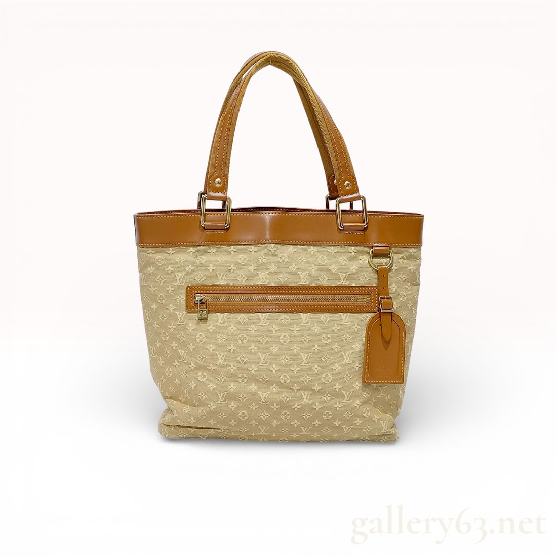 Louis Vuitton Monogram Mini Lucille GM Tote Bag: A Louis Vuitton Lucille GM tote bag crafted from beige Monogram Mini Lin canvas with tan leather trim. The exterior features a horizontal zippered pocket on the front face, accented with a gold-toned 