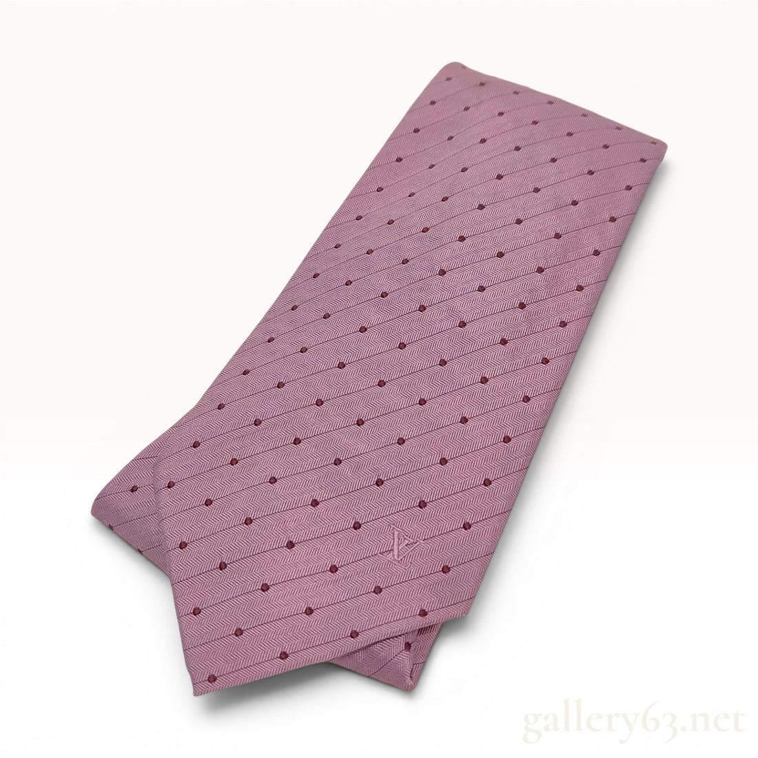 Louis Vuitton 100% Silk Herringbone Polka Dot Necktie: A men's necktie by Louis Vuitton crafted from 100% silk. The design features a mauve herringbone woven ground decorated with a regular pattern of small burgundy dots. The necktie displays multiple bra