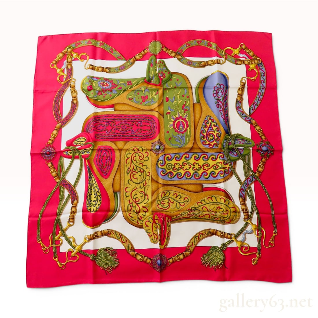 Hermes Festival Silk Scarf by Henri d'Origny: An Hermes silk twill scarf in the Festival pattern, originally designed by Henri d'Origny in 1992. The design features an intricate equestrian motif composed of highly decorated saddles and harnesses.