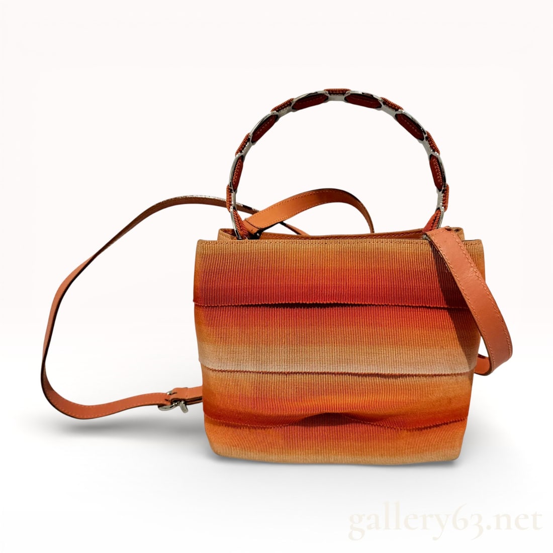 Salvatore Ferragamo Tiered Ombre Grosgrain Bucket Bag: Salvatore Ferragamo bucket bag featuring a tiered exterior of horizontal ombre-dyed grosgrain fabric strips transitioning from deep orange to cream. The structure is defined by an orange leather base 