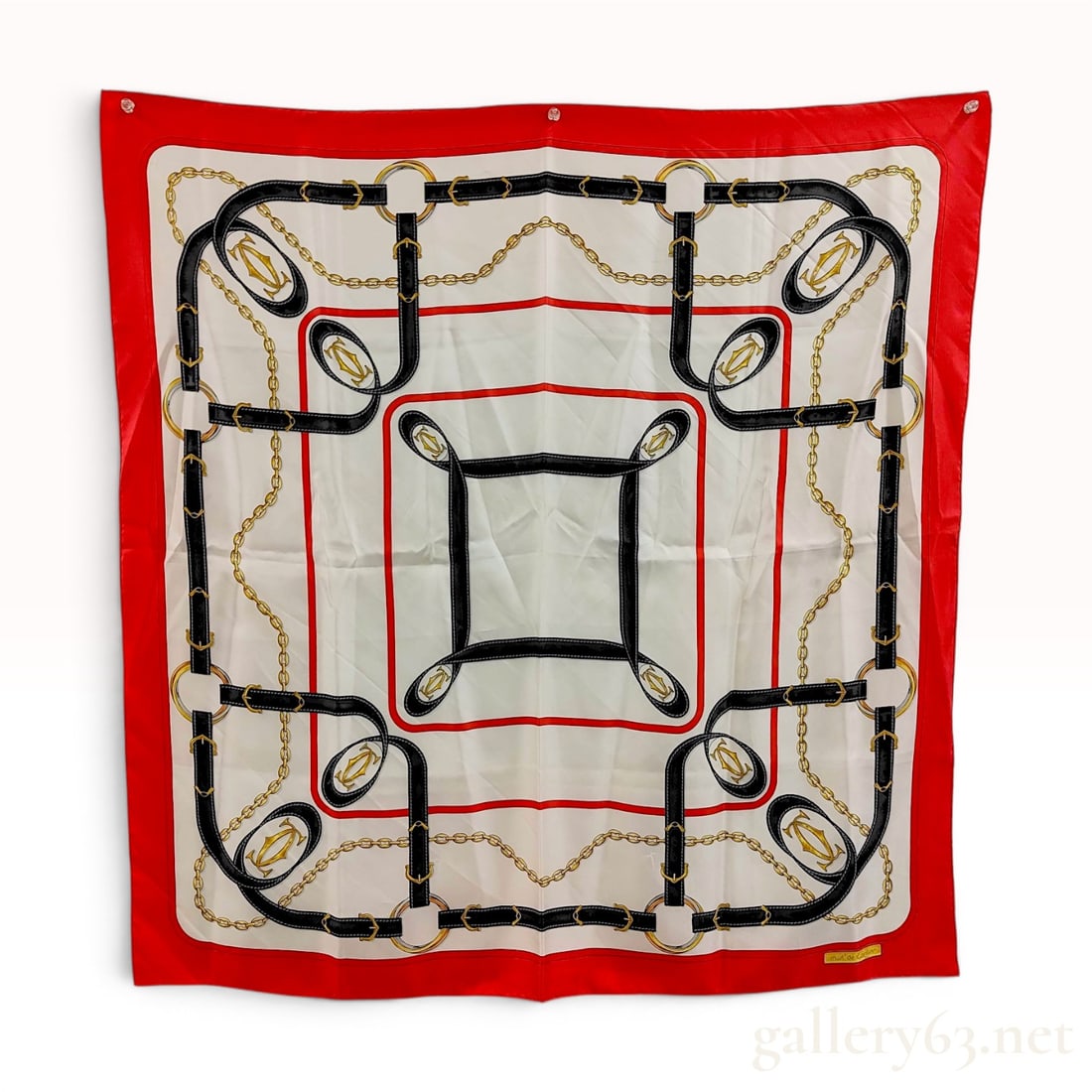 Must de Cartier Silk Scarf with Equestrian and Chain Motif: A vintage silk square scarf by must de Cartier featuring a classic equestrian and jewelry-inspired design. The composition features a central white field decorated with printed black leather-style str