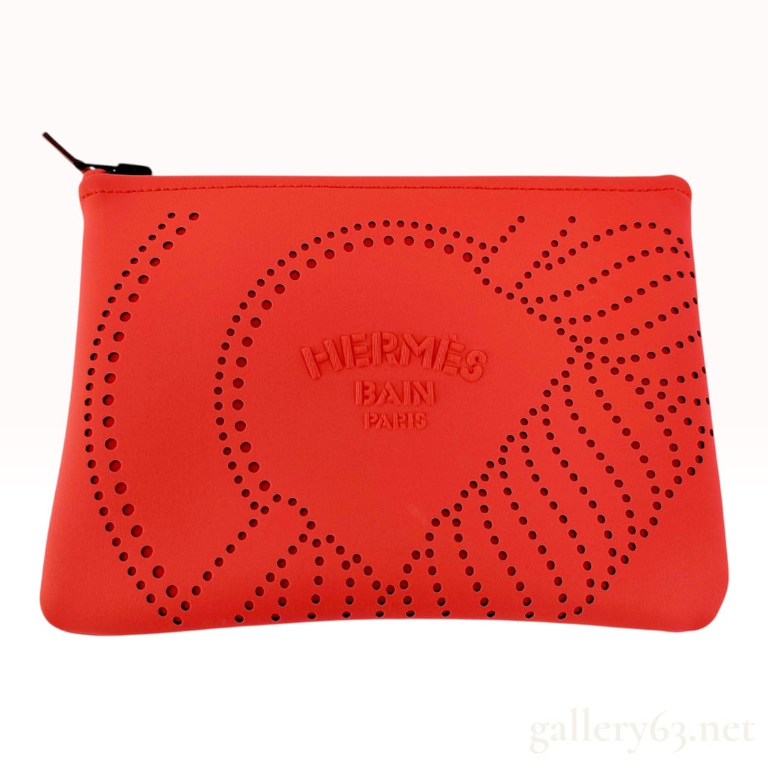 Hermes Orange Neoprene Neobain Waves Pouch PM: This Hermes Neobain Waves pouch is crafted from a vibrant orange, water-resistant blend of 80 percent polyamide and 20 percent elastane. The front features a wave-like motif formed by a pattern of cir