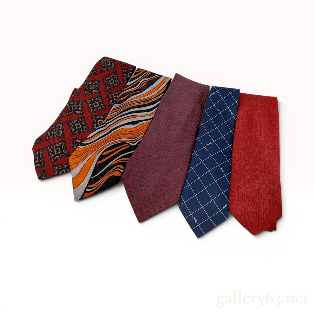 Lot of Five Yves Saint Laurent Silk Neckties: Lot of five vintage Yves Saint Laurent silk neckties in assorted geometric and abstract patterns. The collection includes 100% silk ties featuring geometric diamond, abstract wavy stripe, navy windowp