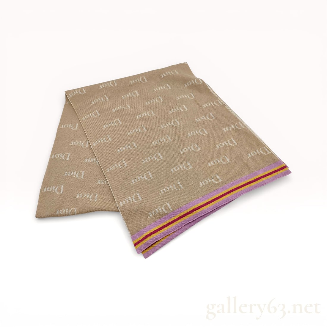 Christian Dior Reversible Logo Knitted Scarf: Christian Dior reversible knitted scarf, contemporary. The jacquard-style knit features a repeating Dior logo pattern in cream and tan, finished with lavender, yellow, and burgundy horizontal stripes 