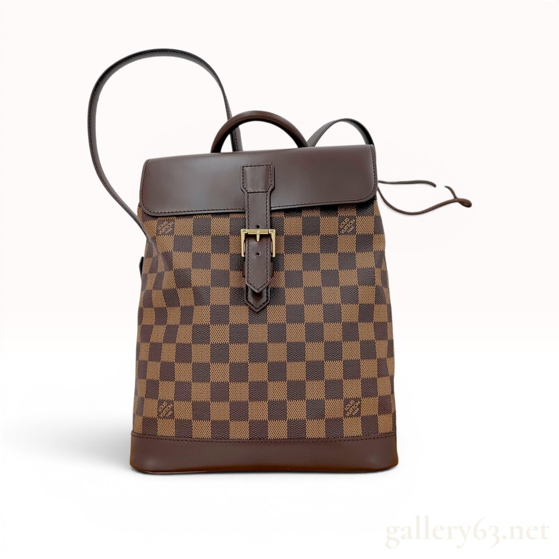Louis Vuitton Damier Ebene Soho Backpack: Louis Vuitton Soho backpack crafted in signature Damier Ebene checkerboard coated canvas with dark brown leather trim. Design features a structured leather base, adjustable shoulder straps, a rolled t