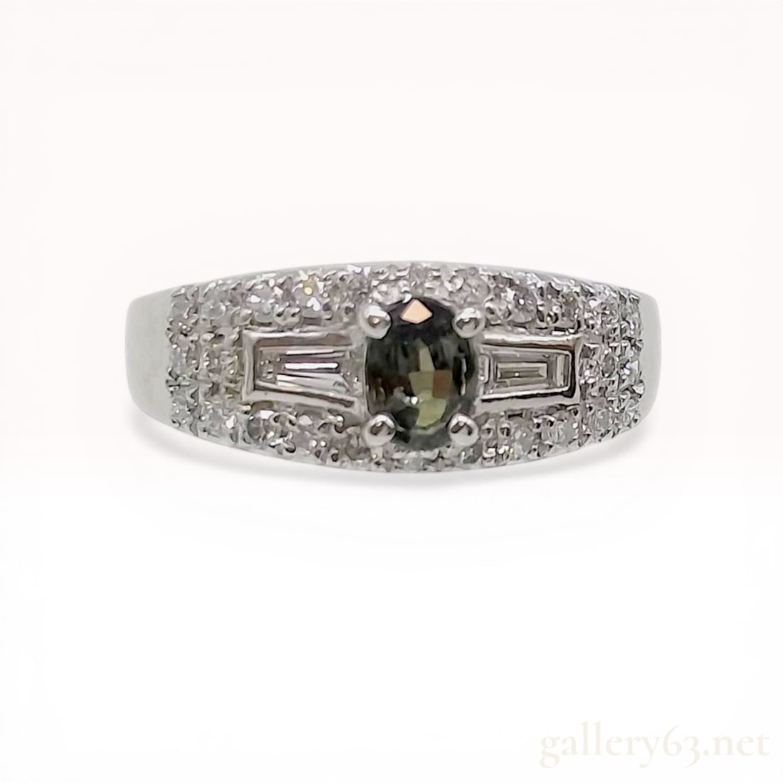 flag - redo , alexandrite, add gia photo: Platinum cocktail ring featuring an oval-cut green sapphire center stone in a four-prong setting, flanked by two tapered baguette diamonds and accented with pave-set round brilliant diamonds on the sh
