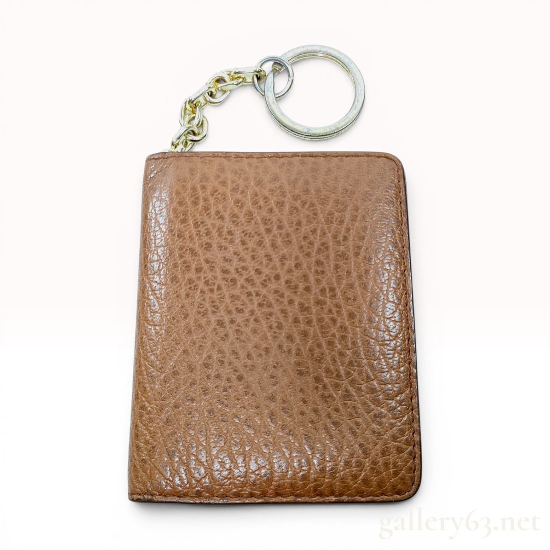 Maison Margiela Pebbled Leather Bifold Keychain Wallet: A Maison Margiela bifold wallet constructed from tan pebbled leather with tonal stitching. The exterior reverse features the signature four white diagonal corner stitches. The interior layout includes