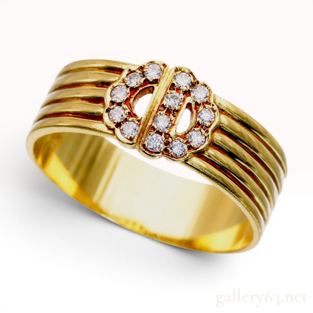 Christian Dior 18kt Yellow Gold and Diamond Logo Band Ring: A Christian Dior band ring crafted from 18kt yellow gold. The wide band is composed of four parallel, rounded horizontal ribs. The central decorative element features an interlocking CD logo, which is