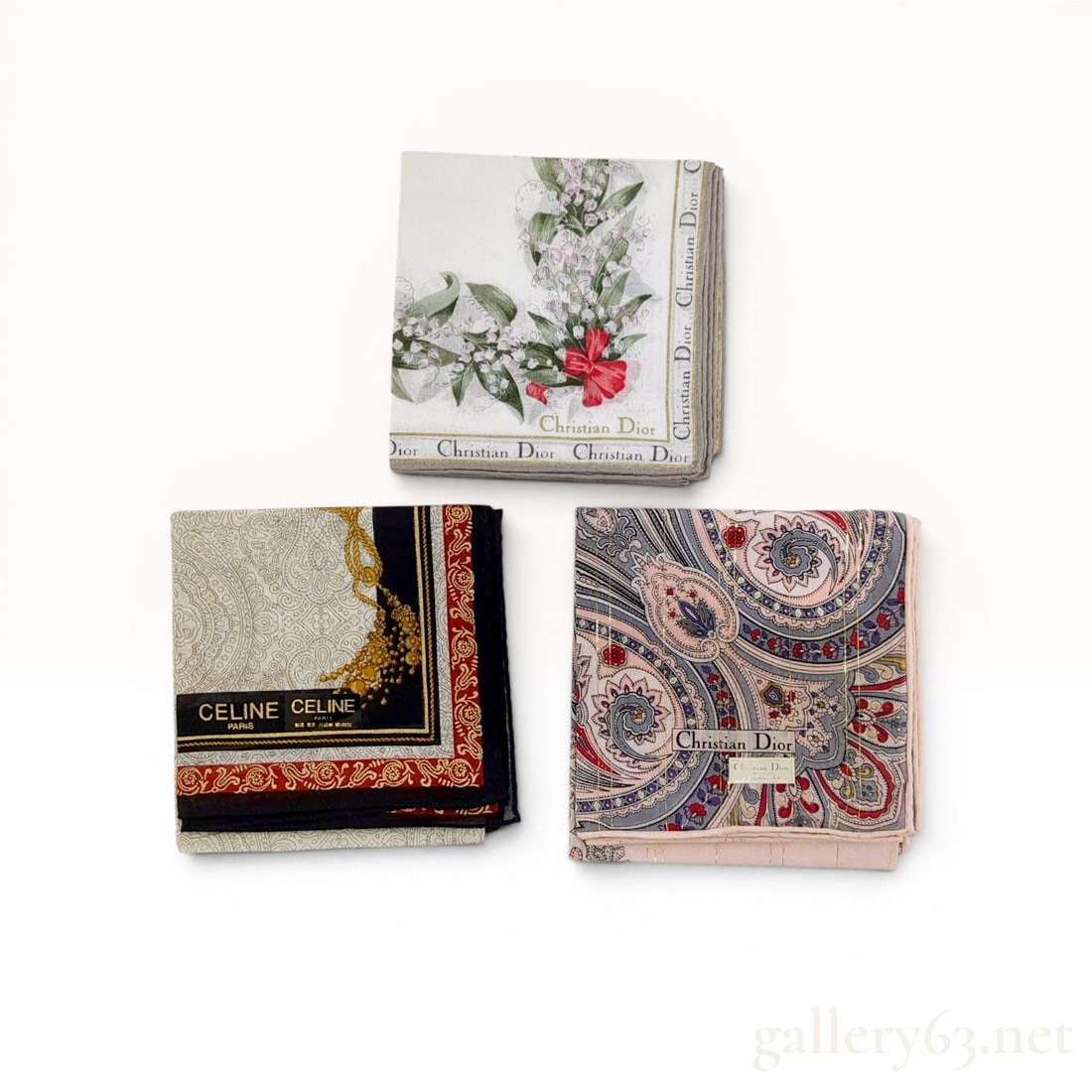 A Trio of Celine and Christian Dior Designer Scarves: A trio of designer scarves featuring one Celine Paris and two Christian Dior examples. The lot includes a Celine paisley and chain design, a Dior multi-colored paisley with metallic thread, and a Dior