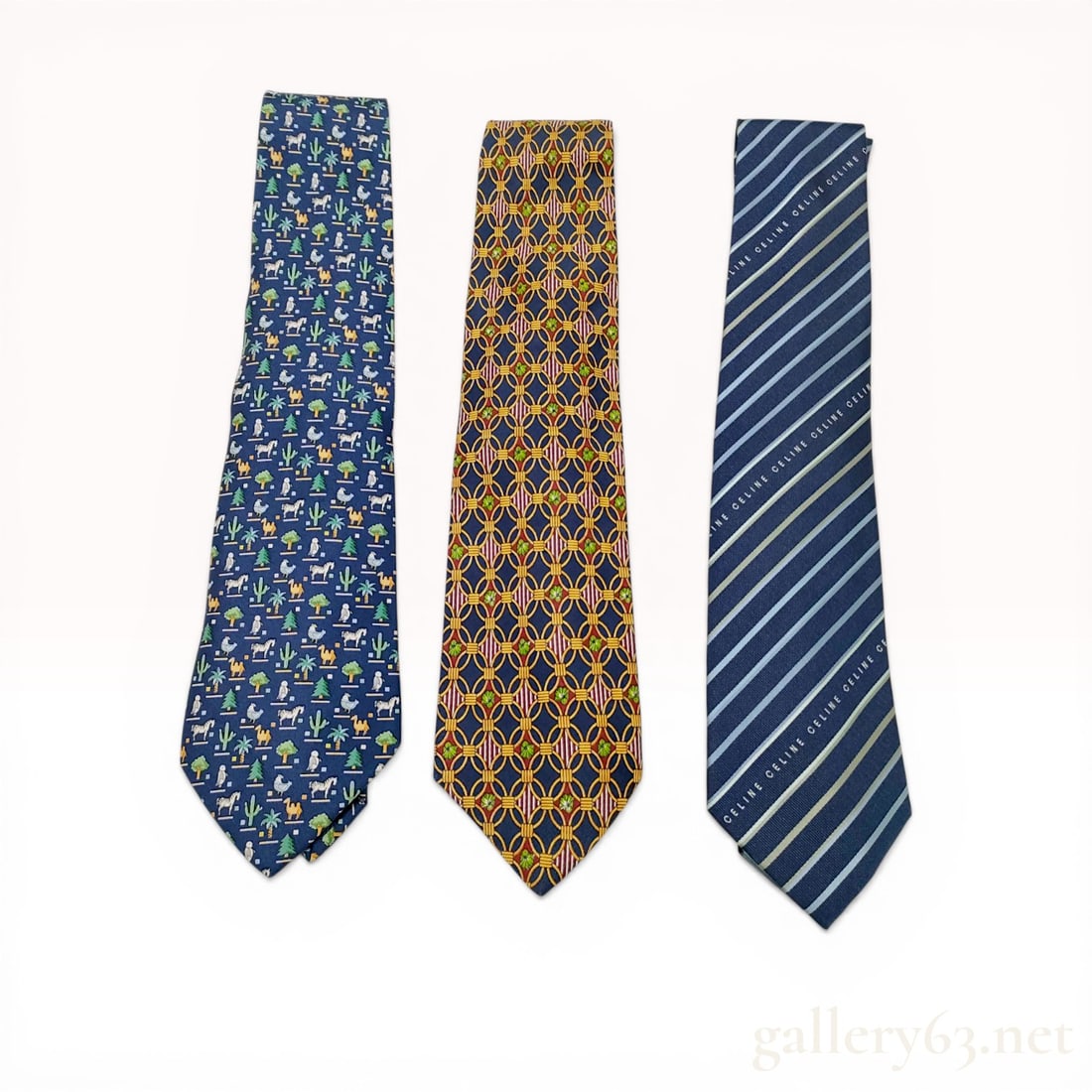 A Trio of Designer Silk Neckties by Salvatore Ferragamo, Christian Dior, and Celine: Three designer silk neckties featuring diverse patterns from Salvatore Ferragamo, Christian Dior Monsieur, and Celine. The assortment includes a Ferragamo animal and desert motif on a navy ground, a D