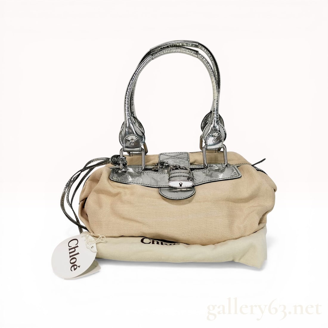 Chloe Paddington Satchel in Beige Canvas and Metallic Silver Leather: Chlo Paddington satchel featuring a ribbed beige corded canvas body with metallic silver leather trim and rolled handles. The design includes the signature oversized silver-tone padlock and key, a top