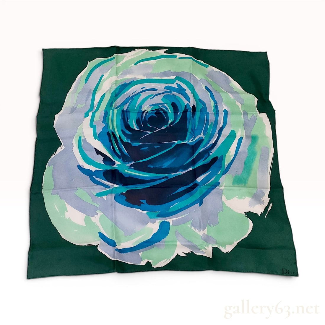 Christian Dior Rose Print Silk Scarf with Original Box: A Christian Dior square silk scarf featuring a stylized oversized rose motif. The graphic design is rendered in a painterly style with petals in shades of royal blue, turquoise, teal, lavender, and wh