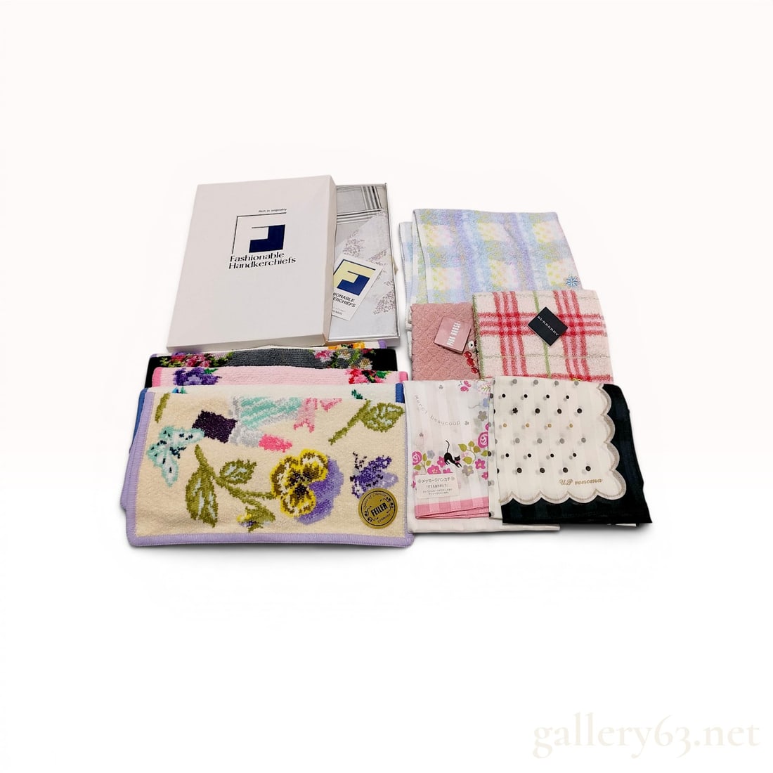 An Assortment of Designer Pocket Squares and Home Accessories Including Burberry, Feiler, and Pink: An assortment of designer pocket squares and small hand towels featuring brands such as Burberry, Feiler, Pink House, Merci Beaucoup, and U. P renoma. The collection is composed of cotton, chenille, a